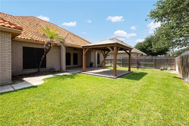 2729 Biltmore Ave, Edinburg, TX 78539 - rear view of property with a ceiling fan, a tile roof, a patio, a gazebo, and brick siding