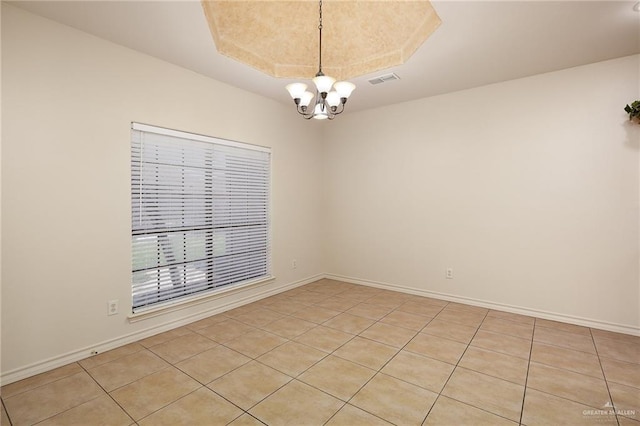 2729 Biltmore Ave, Edinburg, TX 78539 - unfurnished room with a chandelier, light tile patterned flooring, baseboards, and a tray ceiling