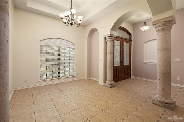 2729 Biltmore Ave, Edinburg, TX 78539 - entryway featuring arched walkways, light tile patterned flooring, decorative columns, a chandelier, and baseboards