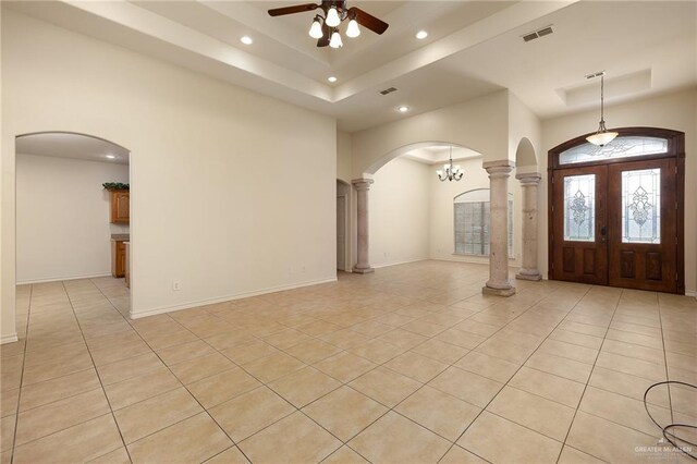 2729 Biltmore Ave, Edinburg, TX 78539 - foyer entrance featuring arched walkways, light tile patterned floors, recessed lighting, ceiling fan, and a tray ceiling