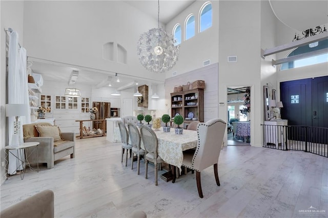 1909 Lake Point Dr, Mission, TX 78572 - dining room with light wood finished floors, a high ceiling, a wealth of natural light, and a chandelier