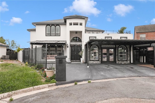 1909 Lake Point Dr, Mission, TX 78572 - view of front of home featuring fence, french doors, central AC, and stucco siding