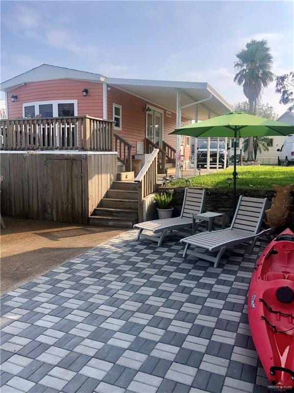 back of house featuring a patio area and a wooden deck