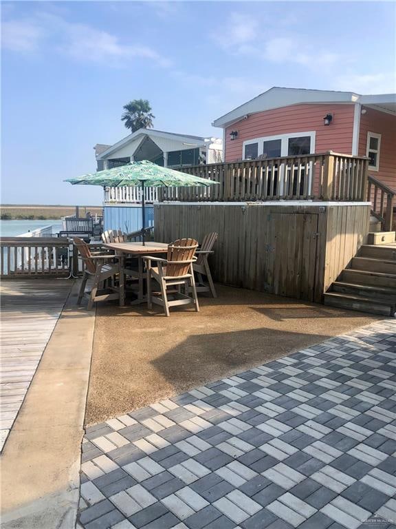 view of patio featuring a deck with water view