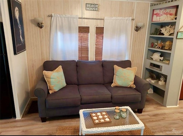 living room featuring hardwood / wood-style floors and built in features