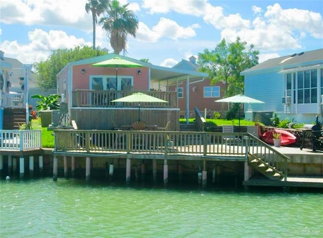 rear view of property featuring a deck with water view