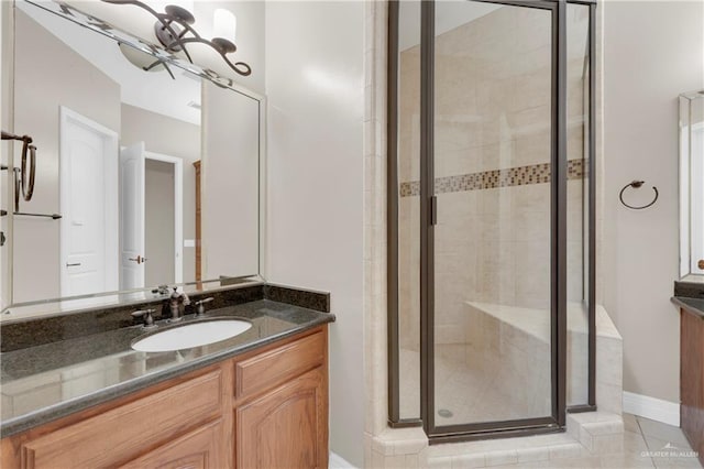 bathroom featuring tile patterned flooring, vanity, and walk in shower