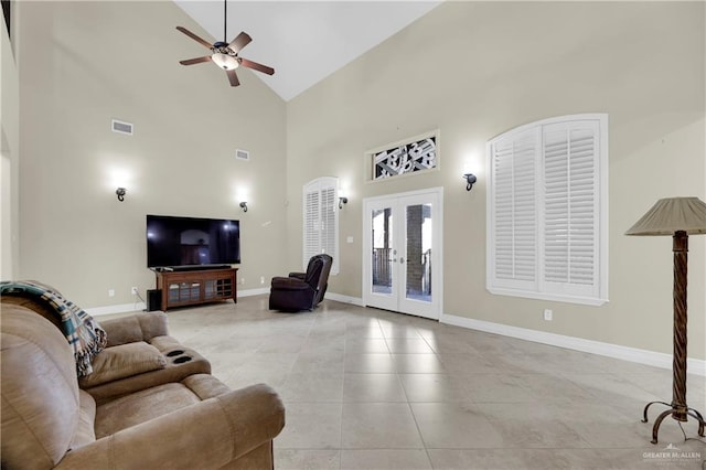 tiled living room featuring ceiling fan, french doors, and high vaulted ceiling