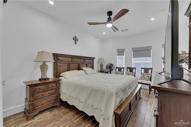 bedroom with light wood-type flooring, multiple windows, and ceiling fan