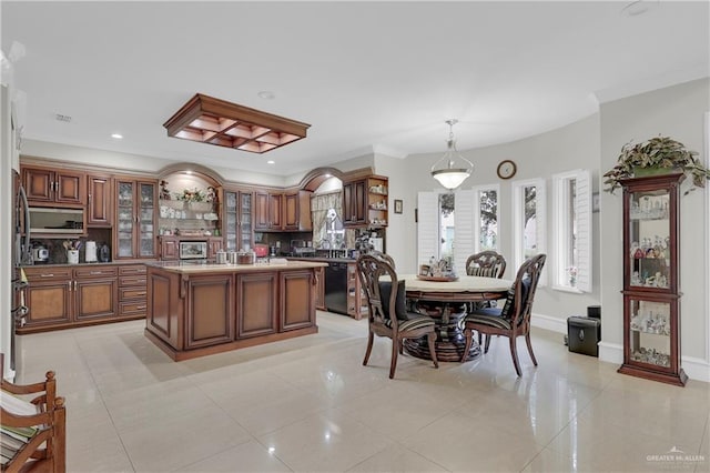 dining room featuring light tile patterned floors and ornamental molding