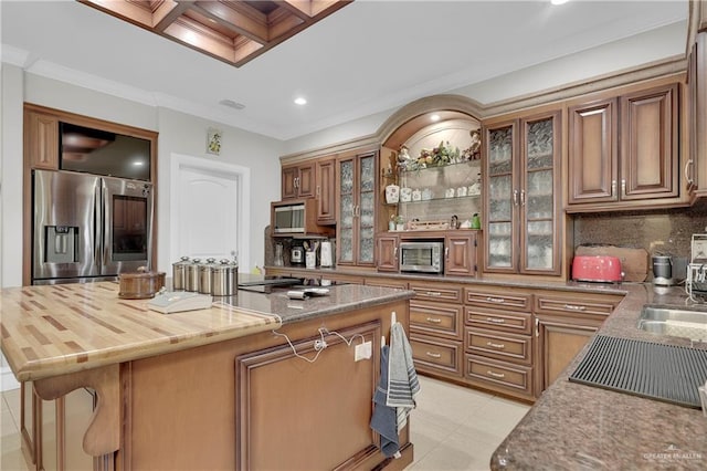 kitchen with a center island, stainless steel appliances, coffered ceiling, a breakfast bar area, and ornamental molding