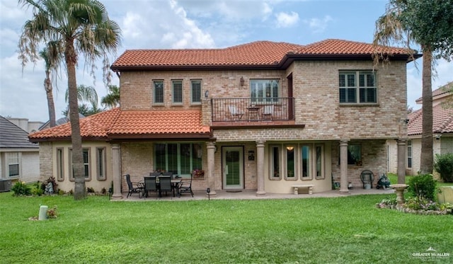 rear view of house featuring a lawn, a patio area, a balcony, and cooling unit