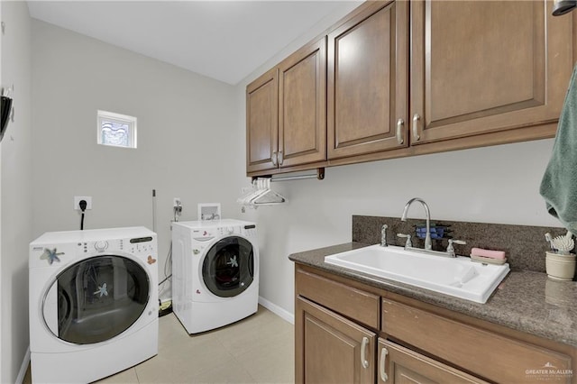 laundry room with cabinets, sink, and washing machine and dryer