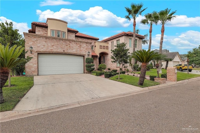 mediterranean / spanish house with a front yard and a garage