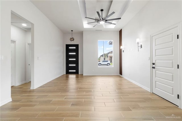entrance foyer featuring a ceiling fan, baseboards, visible vents, and light wood-style floors