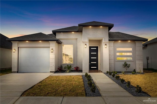 view of front of house with concrete driveway, stucco siding, roof with shingles, and a garage