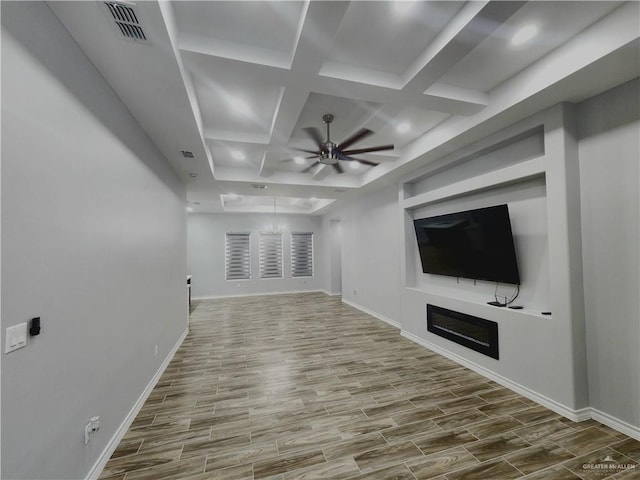 unfurnished living room featuring beam ceiling, ceiling fan, wood-type flooring, and coffered ceiling