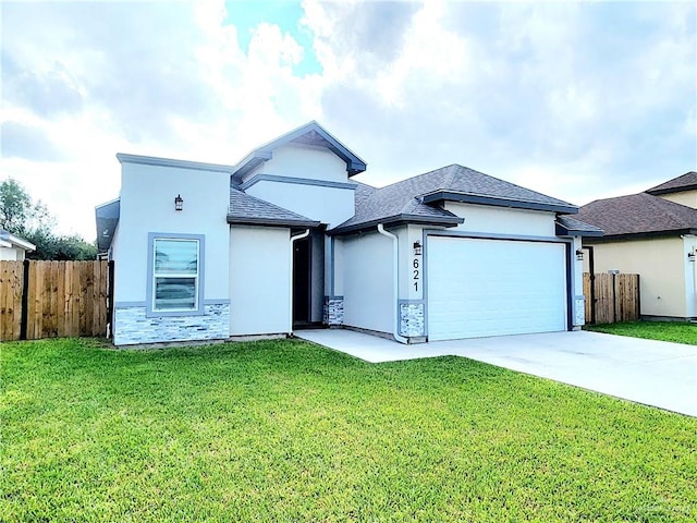 view of front of house featuring a garage and a front lawn