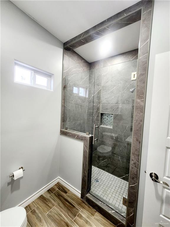 bathroom with toilet and walk in shower