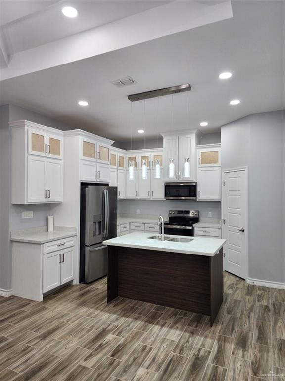 kitchen featuring decorative light fixtures, dark hardwood / wood-style floors, sink, and appliances with stainless steel finishes