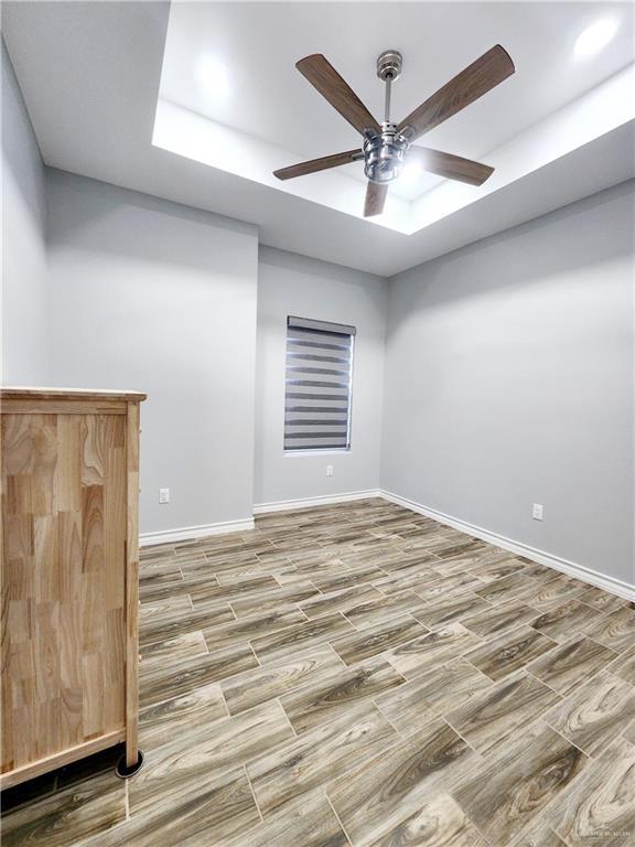 empty room featuring ceiling fan and hardwood / wood-style flooring