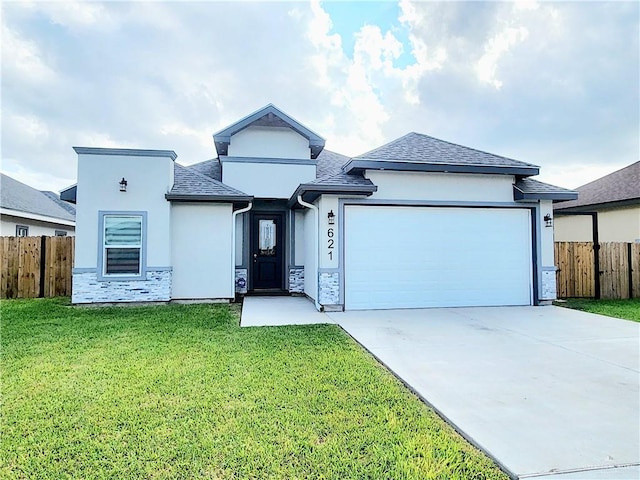 view of front of property featuring a garage and a front lawn