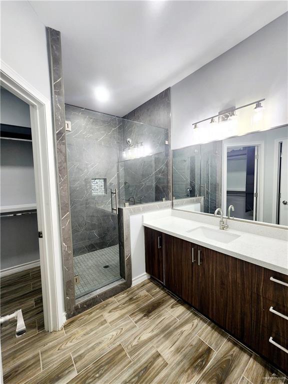 bathroom featuring vanity and an enclosed shower