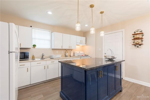 8814 S Mould Dr, Pharr, TX 78577 - kitchen featuring white appliances, exhaust hood, a sink, light wood-style flooring, and white cabinetry