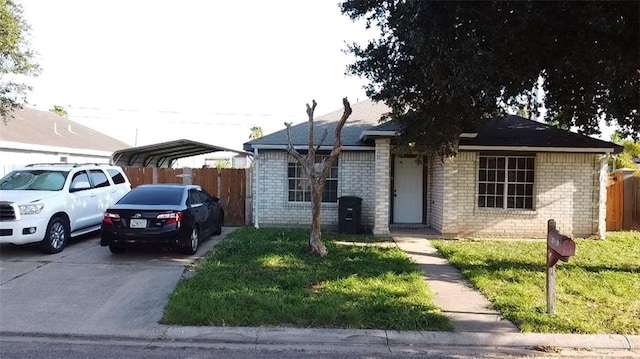 1414 Vatia Blvd, Mission, TX 78572 - view of front of house featuring driveway, a detached carport, and brick siding