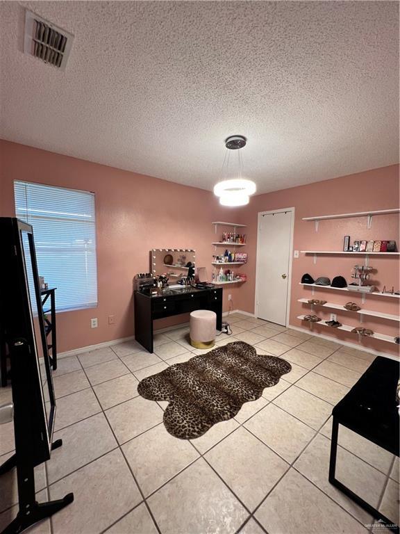 1414 Vatia Blvd, Mission, TX 78572 - dining space with a textured ceiling and light tile patterned floors