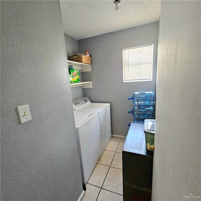 1414 Vatia Blvd, Mission, TX 78572 - laundry area with washer and clothes dryer, light tile patterned floors, a textured ceiling, and a textured wall
