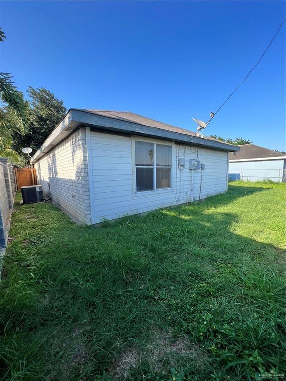 1414 Vatia Blvd, Mission, TX 78572 - view of side of property with brick siding and a fenced backyard