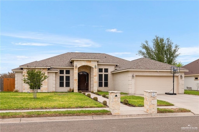 view of front of home featuring a garage and a front lawn