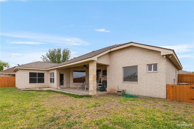 back of house featuring a patio area, ceiling fan, and a yard