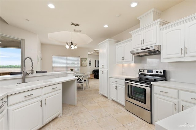 kitchen featuring sink, stainless steel range with electric cooktop, a chandelier, decorative light fixtures, and white cabinets