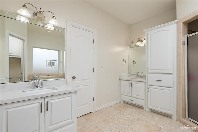 bathroom featuring vanity, an inviting chandelier, tile patterned floors, and walk in shower