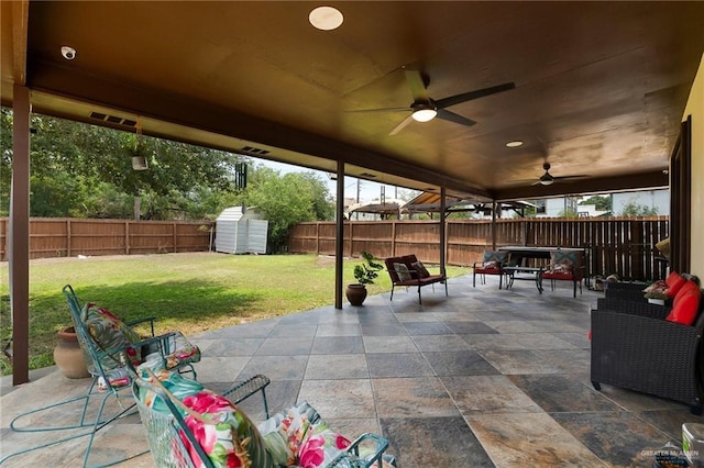 view of patio / terrace featuring ceiling fan, an outdoor living space, and a shed