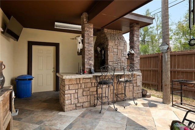 view of patio featuring an outdoor bar