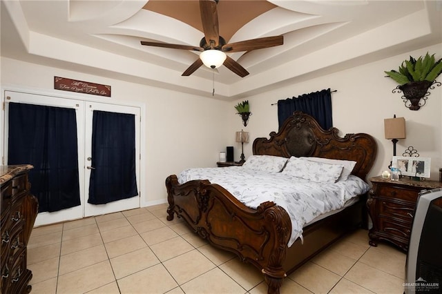 bedroom with french doors, light tile patterned floors, ceiling fan, and a tray ceiling