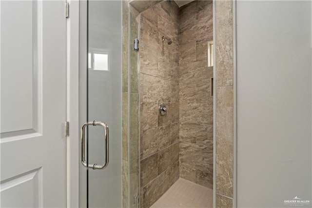 bathroom with a shower with shower door