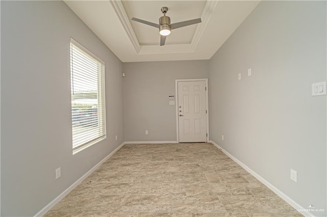 unfurnished room featuring a raised ceiling, ceiling fan, and crown molding