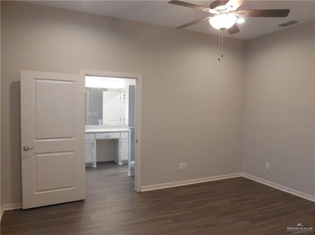 empty room with visible vents, baseboards, dark wood-type flooring, and ceiling fan