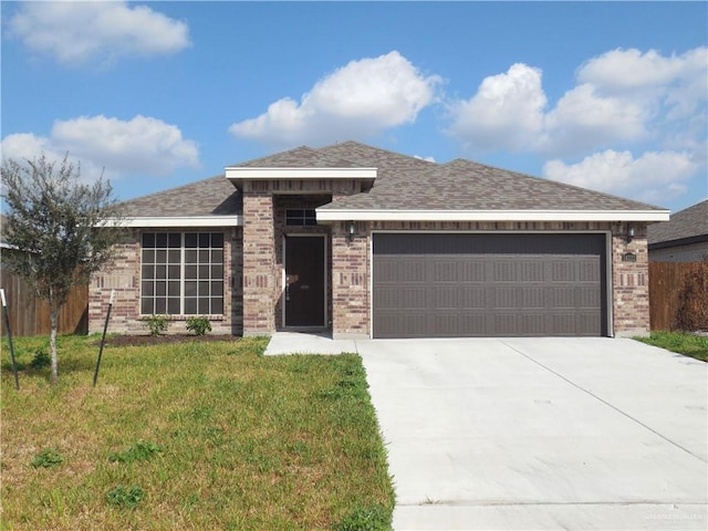 prairie-style house with concrete driveway, an attached garage, and brick siding