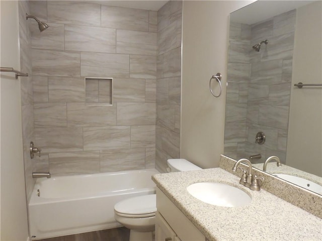 bathroom with vanity, shower / tub combination, and toilet