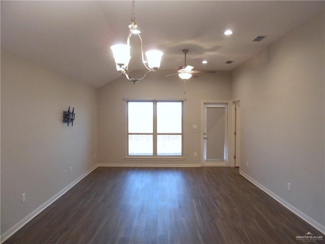 spare room featuring visible vents, baseboards, dark wood finished floors, vaulted ceiling, and ceiling fan with notable chandelier