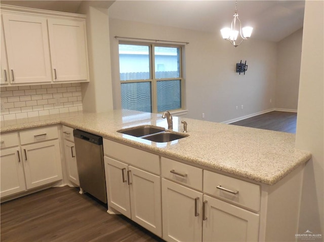 kitchen with a sink, stainless steel dishwasher, dark wood finished floors, white cabinetry, and a peninsula