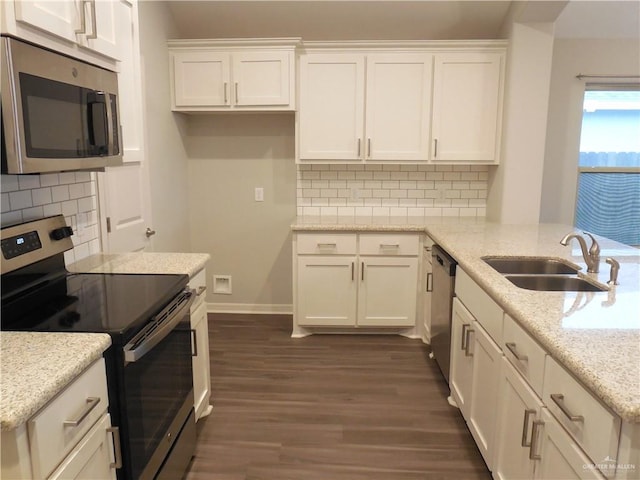 kitchen featuring dark wood-style flooring, white cabinetry, stainless steel appliances, and a sink