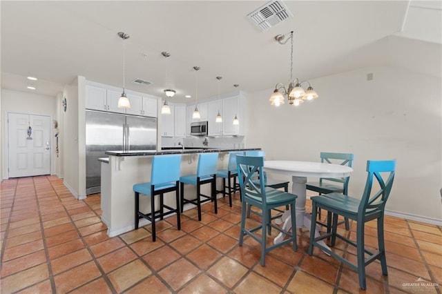 301 Houston Ave, Port Isabel, TX 78578 - dining room featuring a chandelier, recessed lighting, and vaulted ceiling