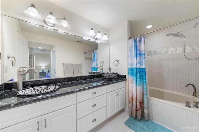 301 Houston Ave, Port Isabel, TX 78578 - full bath with tiled shower / bath, double vanity, tile patterned flooring, and recessed lighting