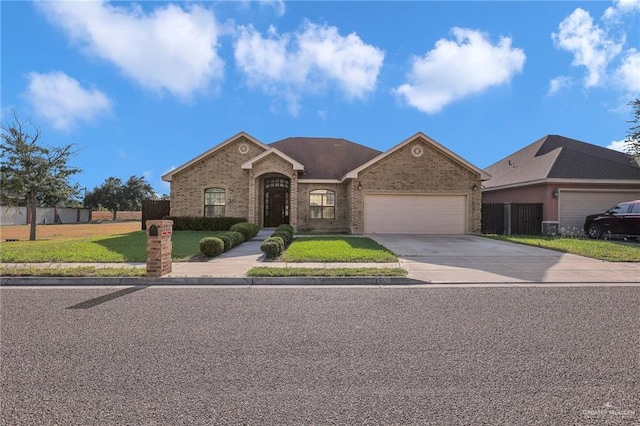 3517 N 43rd St, Mcallen, TX 78501 - view of front of property featuring a garage, brick siding, concrete driveway, and a front yard